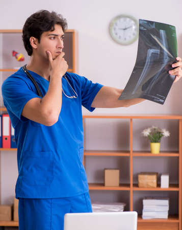 Young handsome doctor working in the hospital