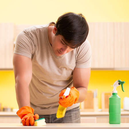 The single man cleaning kitchen at homeの写真素材