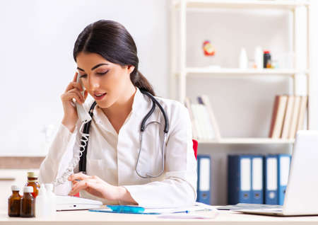 Doctor in telemedicine concept with phoneの写真素材