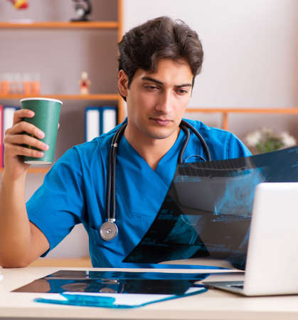 Young handsome doctor radiologyst working in clinic