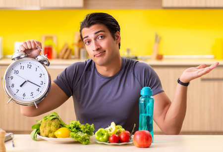 Young man in dieting and healthy eating conceptの写真素材
