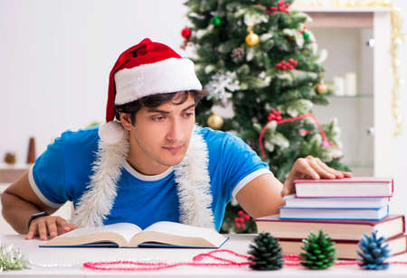 Young student with book at Christmas eveの写真素材