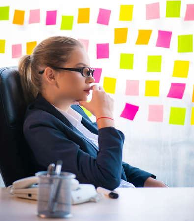 Beautiful female employee with many conflicting prioritiesの写真素材