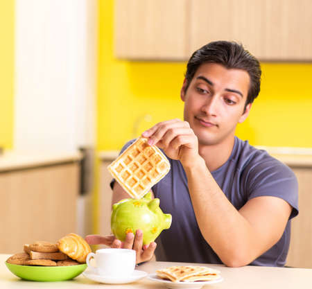 Young man in unhealthy food conceptの写真素材