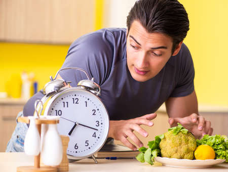 Young man in dieting and healthy eating conceptの写真素材