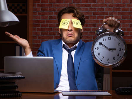 Young businessman working in the office at night