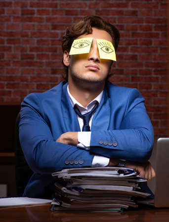 Young businessman working in the office at nightの写真素材