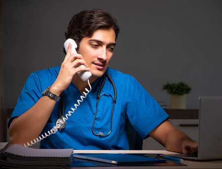 Young handsome doctor working night shift in hospital