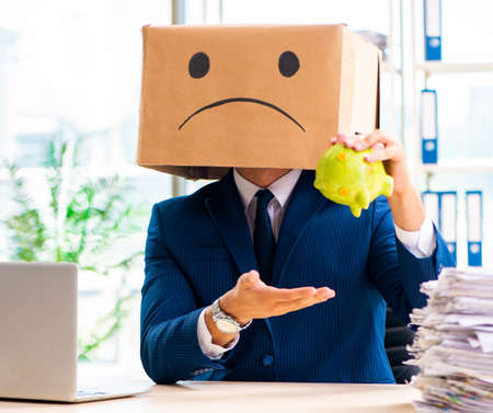 Unhappy man with box instead of his headの写真素材