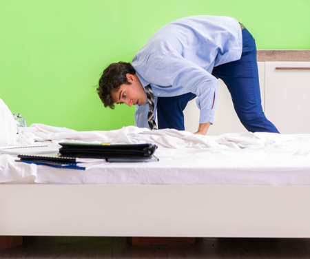 Young businessman employee late for officeの写真素材