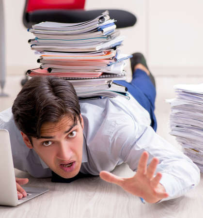 Extremely busy employee working in the office