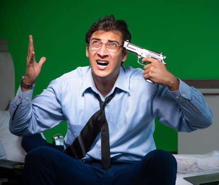 Young businessman under stress in the bedroom at night