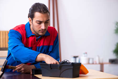 Young male contractor working in workshopの写真素材