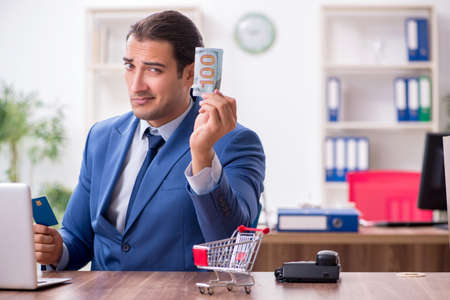 Young male businessman in ecommerce conceptの写真素材