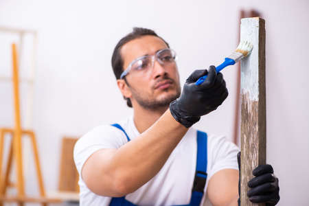 Young male contractor working in workshopの写真素材