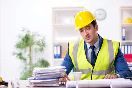 Young male architect working in the office