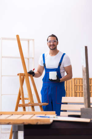 Young male contractor working in workshopの写真素材