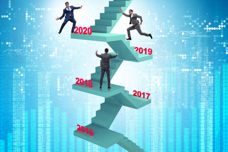 Businessman climbing stairs on yearly basisの写真素材