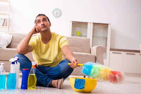 Young male contractor doing housework at home