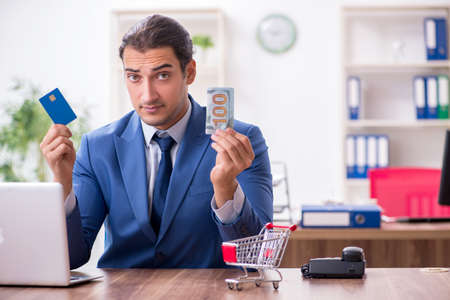 Young male businessman in ecommerce conceptの写真素材