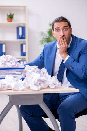 Businessman rejecting new ideas with lots of papersの写真素材
