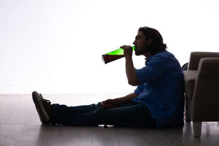 Young man suffering from alcoholismの写真素材