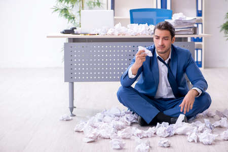 Businessman rejecting new ideas with lots of papers