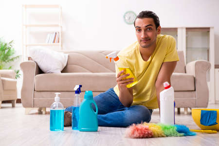 Young male contractor doing housework at home