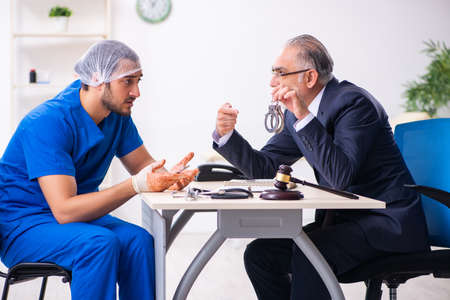 Male doctor in courthouse meeting with advocateの写真素材