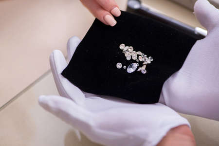 Male jeweler and female client at storeの写真素材