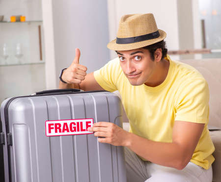 Man going on vacation with fragile suitcasesの写真素材