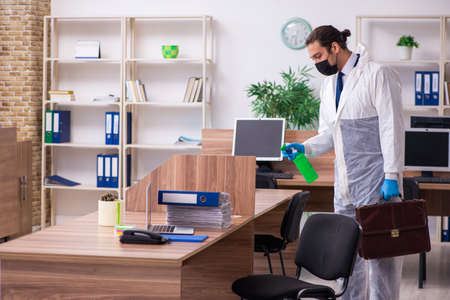 Young male employee in self-isolation conceptの写真素材