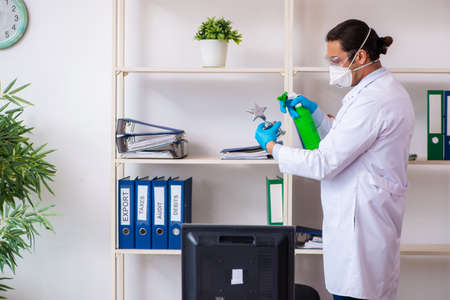 Young male doctor virologist in the officeの写真素材