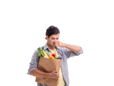 Young man with his grocery shopping on whiteの写真素材
