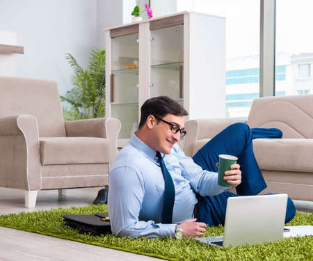 Businessman taking work home and working overtimeの写真素材