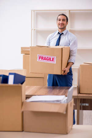 Young male employee in relocation conceptの写真素材