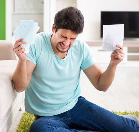 Young man struggling with personal finance and bills