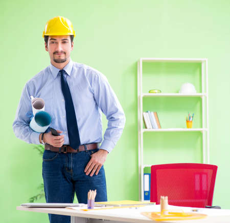 Young male architect working at the project