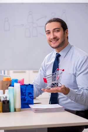 Young male shopaholic in e-commerce conceptの写真素材