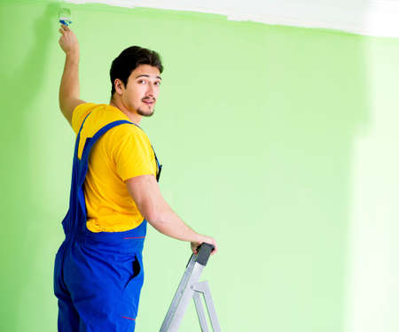 Young painter doing renovation at homeの写真素材