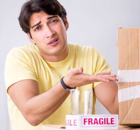 Man moving house and relocating with fragile itemsの写真素材
