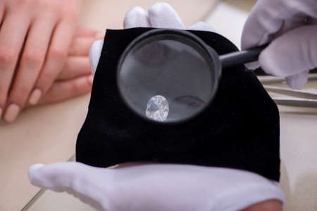 Male jeweler and female client at store