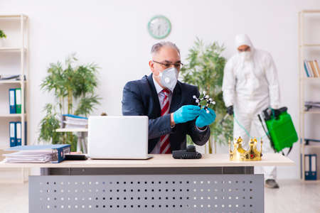 Old employee and young contractor in coronavirus conceptの写真素材