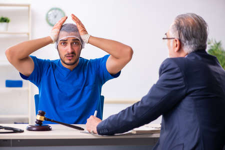Male doctor in courthouse meeting with advocateの写真素材