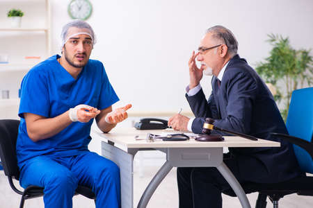 Male doctor in courthouse meeting with advocateの写真素材