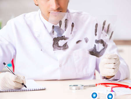 Forensic expert studying fingerprints in the labの写真素材