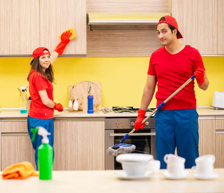 Cleaning professional contractors working at kitchenの写真素材