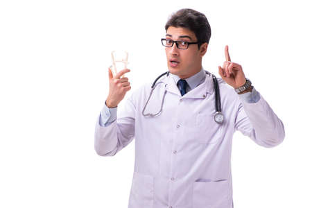 Young male doctor with calipers isolated on whiteの写真素材