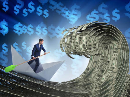 Businessman riding paper boat in dollar seaの写真素材