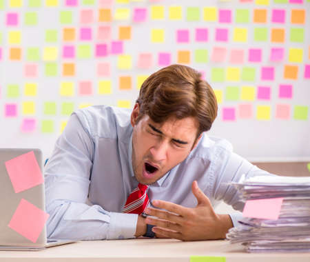 Young handsome man in conflicting priorities conceptの写真素材